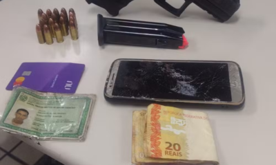 Pistola, munições e dinheiro em espécie apreendidos com policial militar em Campo Grande (Foto: Reprodução)