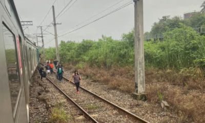 Passageiros caminham por trilhos após problemas nos trens a Supervia