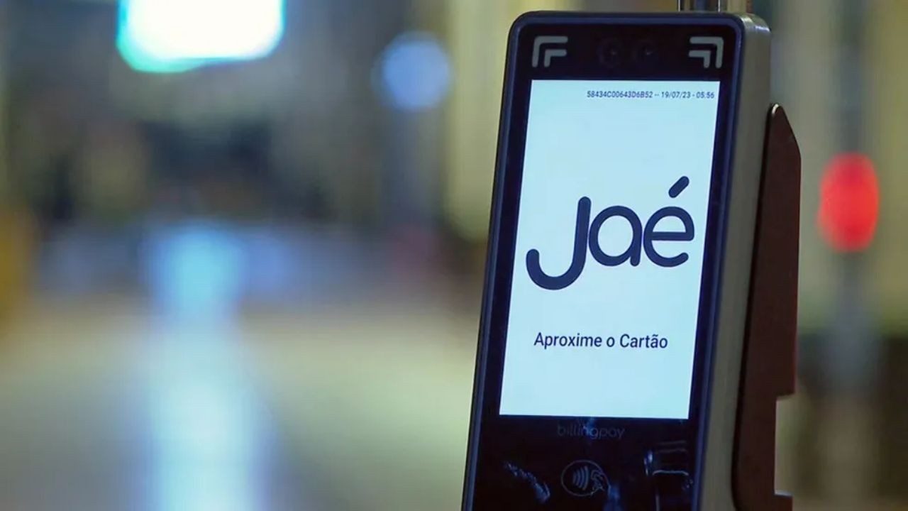 Tela de validador eletrônico de transporte público exibe 'Jaé' e 'Aproxime o Cartão'.