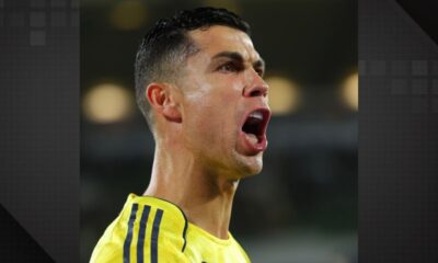 Close-up de Cristiano Ronaldo gritando, usando camisa amarela, expressão intensa, suor no rosto.