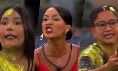 Três mulheres com líquido amarelo nos rostos e roupas, uma de óculos, outra com batom vermelho.