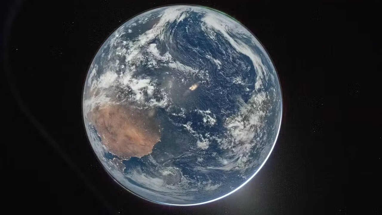 Planeta Terra visto do espaço, com rastro de luz de um lançamento na superfície. Foto: NASA/Reid Wiseman