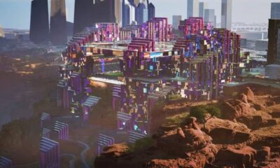 Estádio futurista e complexo urbano colorido em Neom, Arábia Saudita, integrado a deserto.
