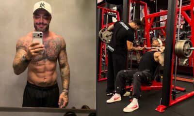Felipe Titto, tatuado, posa para selfie e treina peitoral na academia com personal.