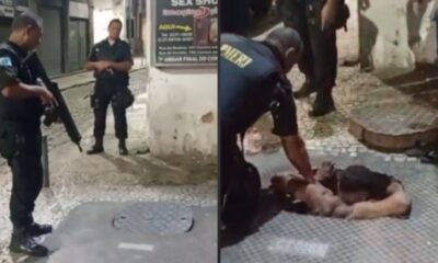 Policiais militares em operação noturna, um armado, outro contendo suspeito no chão