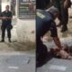 Policiais militares em operação noturna, um armado, outro contendo suspeito no chão