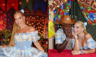 Virginia Fonseca e Vini Jr. sorriem em festa junina com barraca do beijo ao fundo