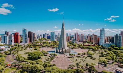 Vista aérea da Catedral de Maringá, estrutura cônica, cercada por área verde e edifícios altos