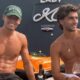 Dois homens sem camisa em barco, segurando taças de vinho, com inscrição "LADY M LONDON"