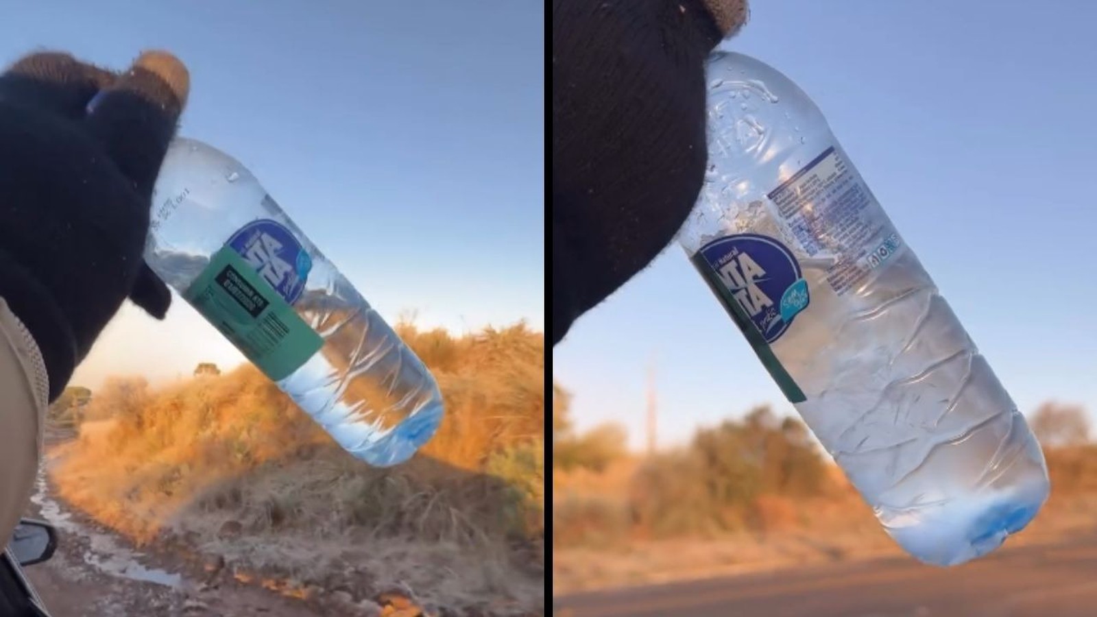 Mão enluvada segurando garrafa de água congelando sobre paisagem árida sob céu azul
