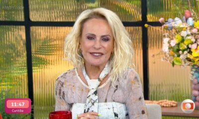 Apresentadora Ana Maria Braga sorrindo com cabelo loiro e maquiagem, exibindo "11:47 Curitiba" na tela