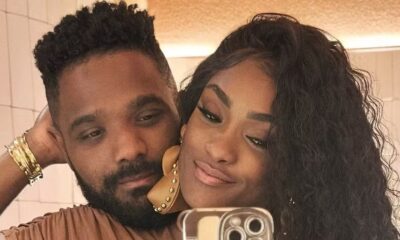Selfie de um casal, homem de barba e mulher de cabelo escuro comprido, sorrindo