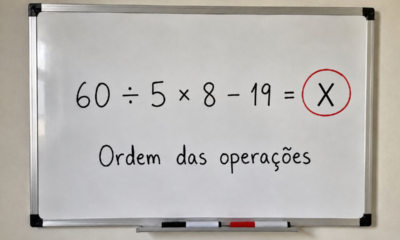 Quadro branco com a expressão “60 ÷ 5 × 8 − 19 = 77” escrita em destaque, com o número 77 circulado em vermelho e a frase “Ordem das operações” abaixo.