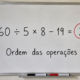 Quadro branco com a expressão “60 ÷ 5 × 8 − 19 = 77” escrita em destaque, com o número 77 circulado em vermelho e a frase “Ordem das operações” abaixo.