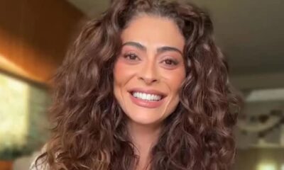 Rosto de Juliana Paes em close-up, sorrindo com cabelo cacheado castanho