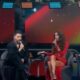 Ana Clara, Anitta, Júnior Lima e Belo em palco de TV com microfones em programa