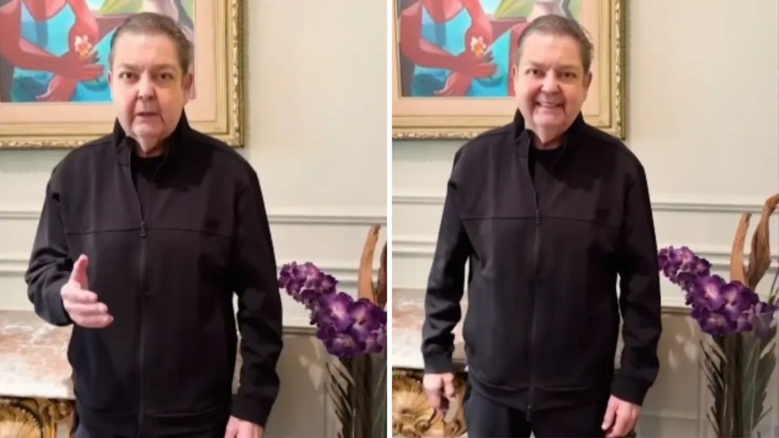 Faustão sorri e gesticula em vídeo, vestindo jaqueta preta, com quadro e flores ao fundo