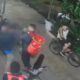 Gravação granulada de câmera de segurança mostrando pessoas durante uma briga na rua