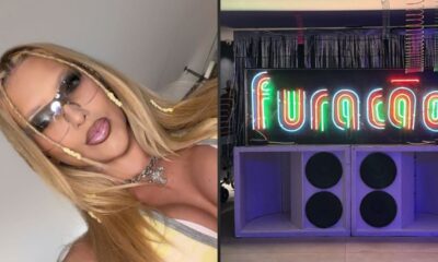 Mulher com óculos e tranças loiras, e neon escrito "furacão" sobre caixas de som