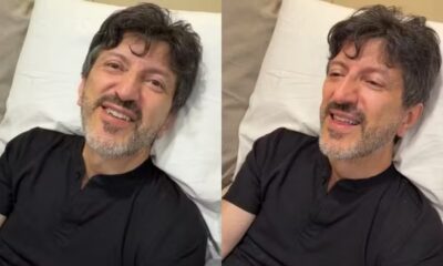 Lito Sousa em cama de hospital, sorrindo e pensativo, usando camisa preta