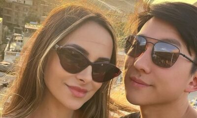 Pyong Lee e Natália Nasser, de óculos escuros, sorrindo em um registro de perto