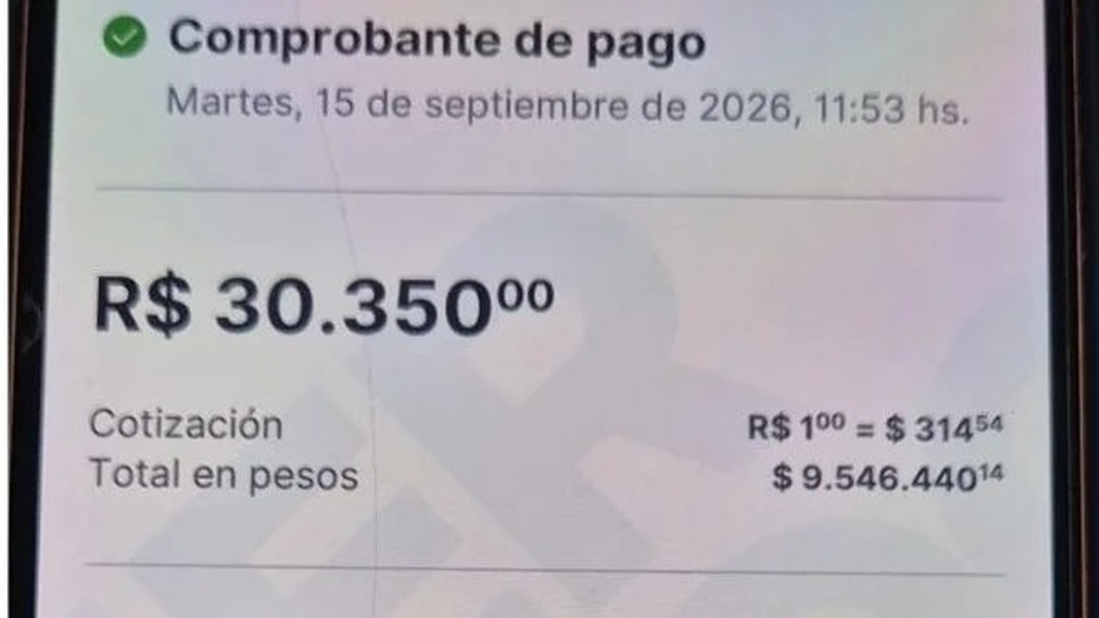 Tela de celular com comprovante de pagamento de R$ 30.350 e detalhes de câmbio