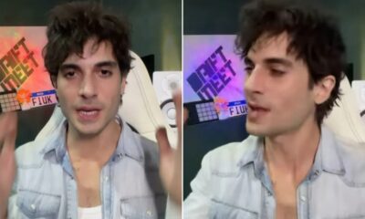 Fiuk em vídeo, cabelo castanho, camisa jeans, gesticulando. Ao fundo, placa 'FIUK' e 'DRIFT MEET'