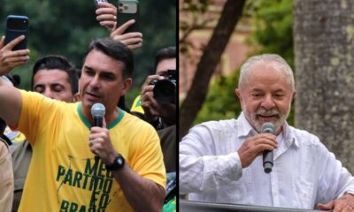 Flávio Bolsonaro, camisa amarela "MEU PARTIDO É O BRASIL", Lula, camisa branca. Ambos com microfone