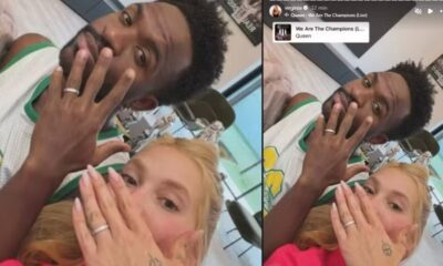 Homem e mulher exibem anéis nas mãos, com detalhes de música “We Are The Champions”