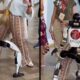 Robô humanoide branco e preto LEGRAND 40 MIGO dança com mulher sorridente em evento.