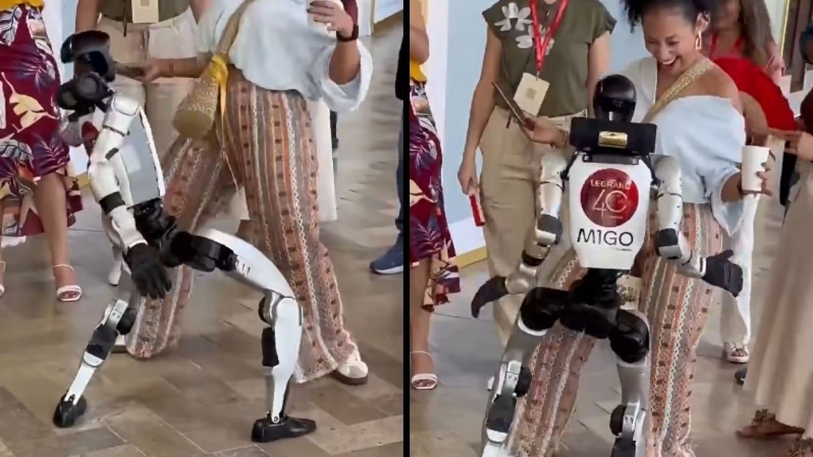 Robô humanoide branco e preto LEGRAND 40 MIGO dança com mulher sorridente em evento.