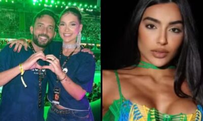 Homem e mulher fazem coração com as mãos, ao lado de mulher de cabelo escuro e top colorido