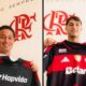 Dois jogadores sorrindo seguram camisas listradas preta e vermelha do Flamengo em frente a um muro com o logo CRF