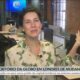 Cecília Malan em escritório, apontando, com gráfico sobre mudança da Globo Londres na tela