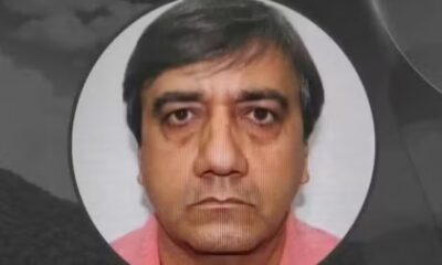 Rosto de homem, cabelo escuro e liso, camisa rosa, em foto de perfil circular