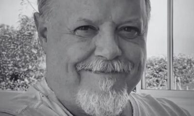 Retrato em preto e branco de Roney Facchini sorrindo com bigode e cavanhaque