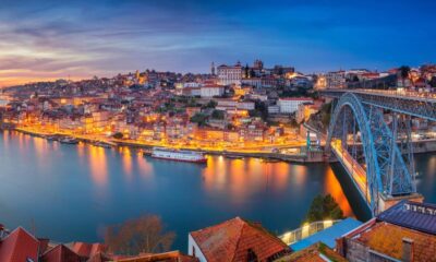 Vista noturna do Porto, Portugal, com rio Douro, ponte Dom Luís I e edifícios iluminados