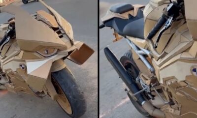 Motocicleta sport com carenagem e detalhes feitos de papelão, estacionada em via pública