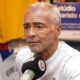 Romário, com cabelo e barba grisalhos, fala em microfone do Charla Podcast em estúdio.