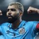 Gabriel Barbosa, camisa azul do Santos, barba e cabelo loiro, flexionando os braços