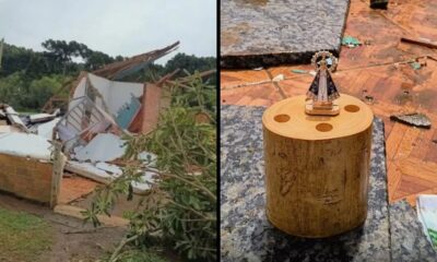 Casa destruída por vendaval e estatueta intacta de Nossa Senhora sobre madeira e destroços