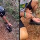 Ciclista, capacete ATHOT, camiseta ZOHOZ, oferece água em mão a filhote preto molhado