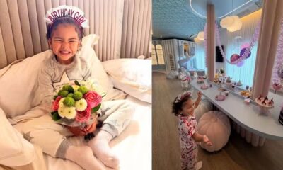 Mavie sorrindo com tiara "Birthday Girl", buquê de flores e em festa de pijama decorada