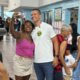 Douglas Ruas sorri em selfie com eleitora, usando camiseta com adesivo '22'