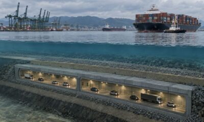 Renderização de um túnel imerso para veículos abaixo da água, com navios e um porto acima