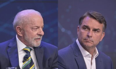 Lula e Flávio Bolsonaro, de terno, em estúdio de televisão