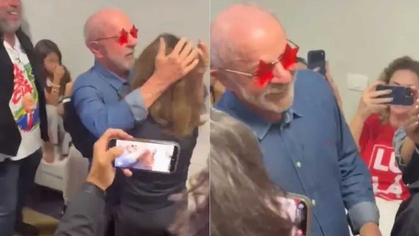 Lula, de óculos estrela, abraça mulher, pessoas filmam. Em segundo plano, camisa com "L"