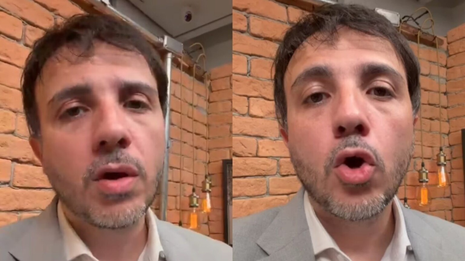 Homem com cabelo escuro e barba, vestindo terno claro, fala em frente a uma parede de tijolos