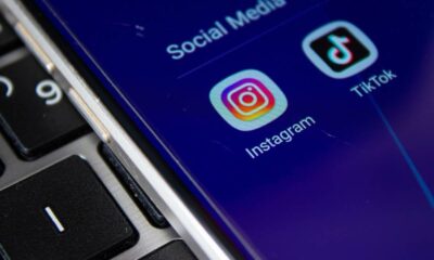 Smartphone screen displays Instagram and TikTok app icons on blue, beside a black keyboard