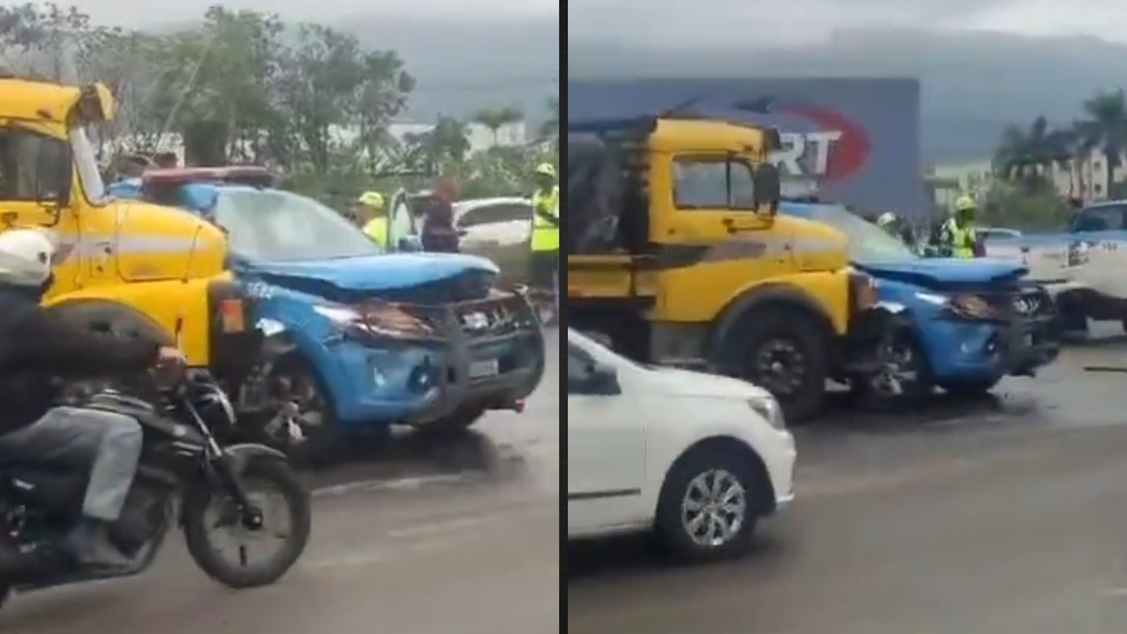 Caminhão amarelo colidiu com viatura policial azul danificada. Cena de acidente em rua molhada, com pessoas